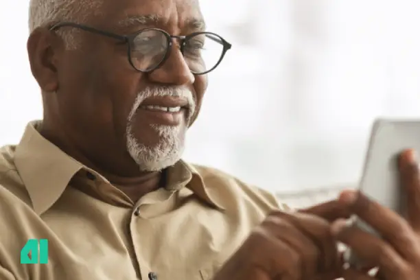 Old man holding a phone and smiling. using phone